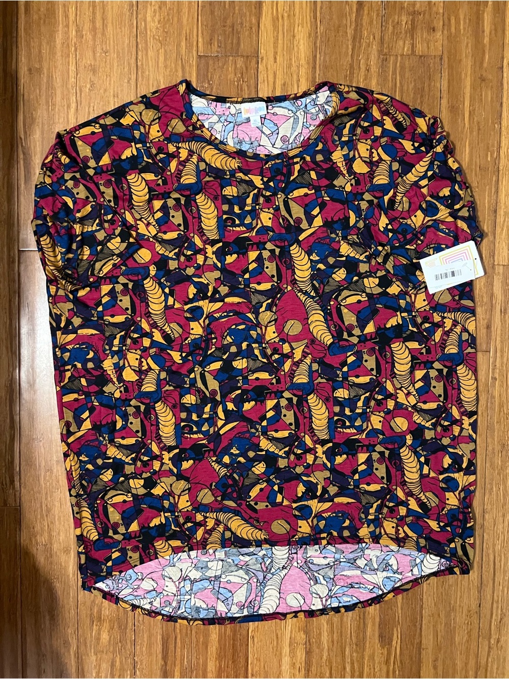 LuLaRoe Irma Pink, Blue, Purple & Yellow Abstract Print Top